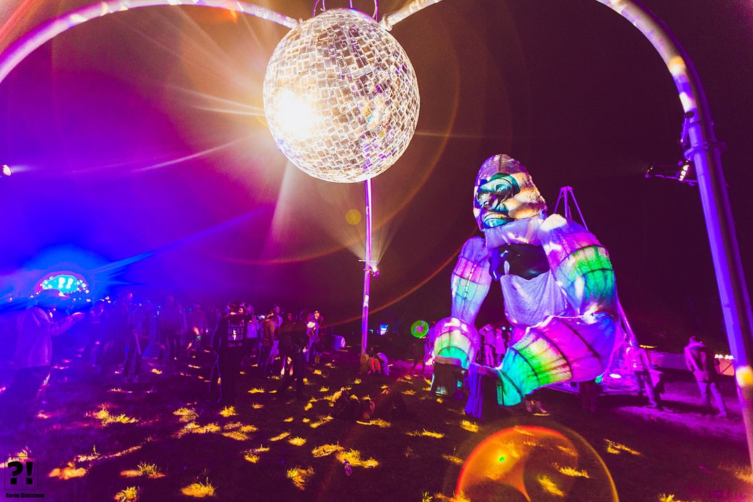 What is Psytrance? 1 Illuminated festival installation beneath a disco ball at night.