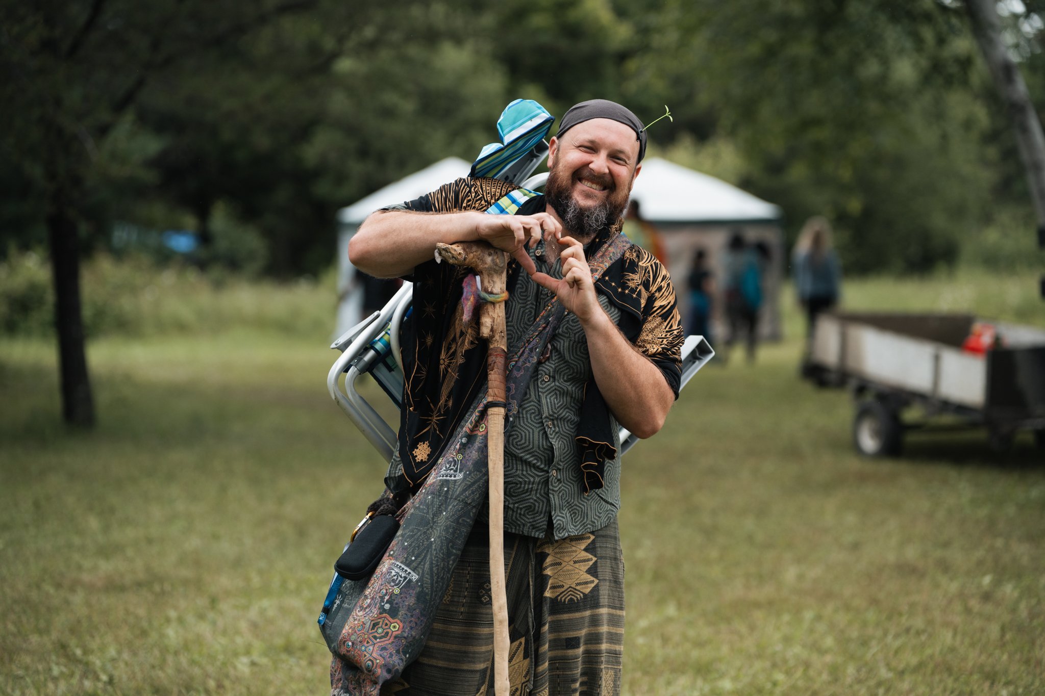 A Sonic Springs attendee stands among trees and tents at the festival.